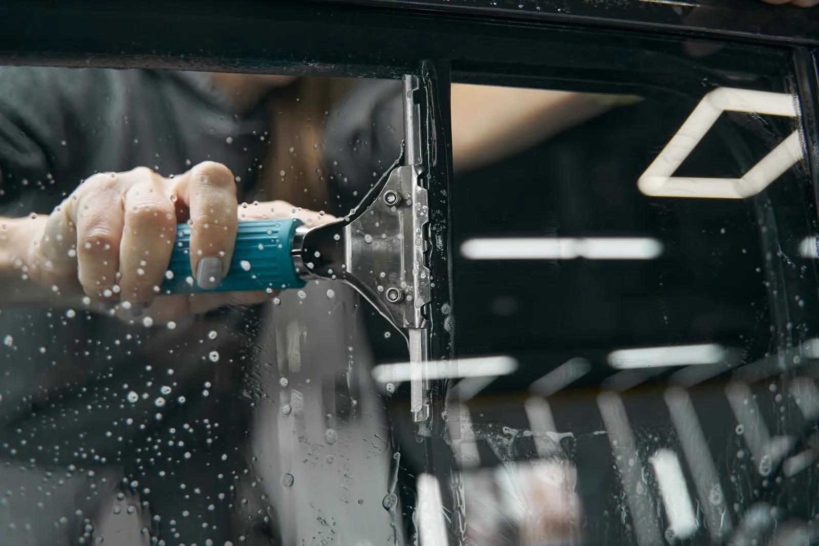 car detailing specialist cleaning the car with the special tool