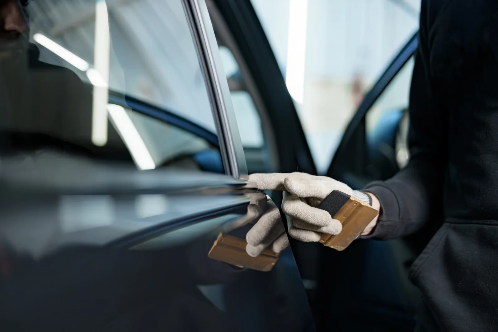 close up of male car service worker applying nano coating on a car