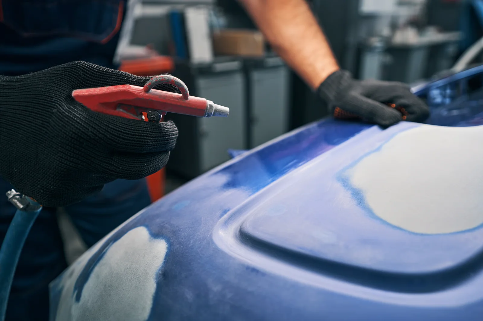 auto mechanic inspecting and repairing car in garage