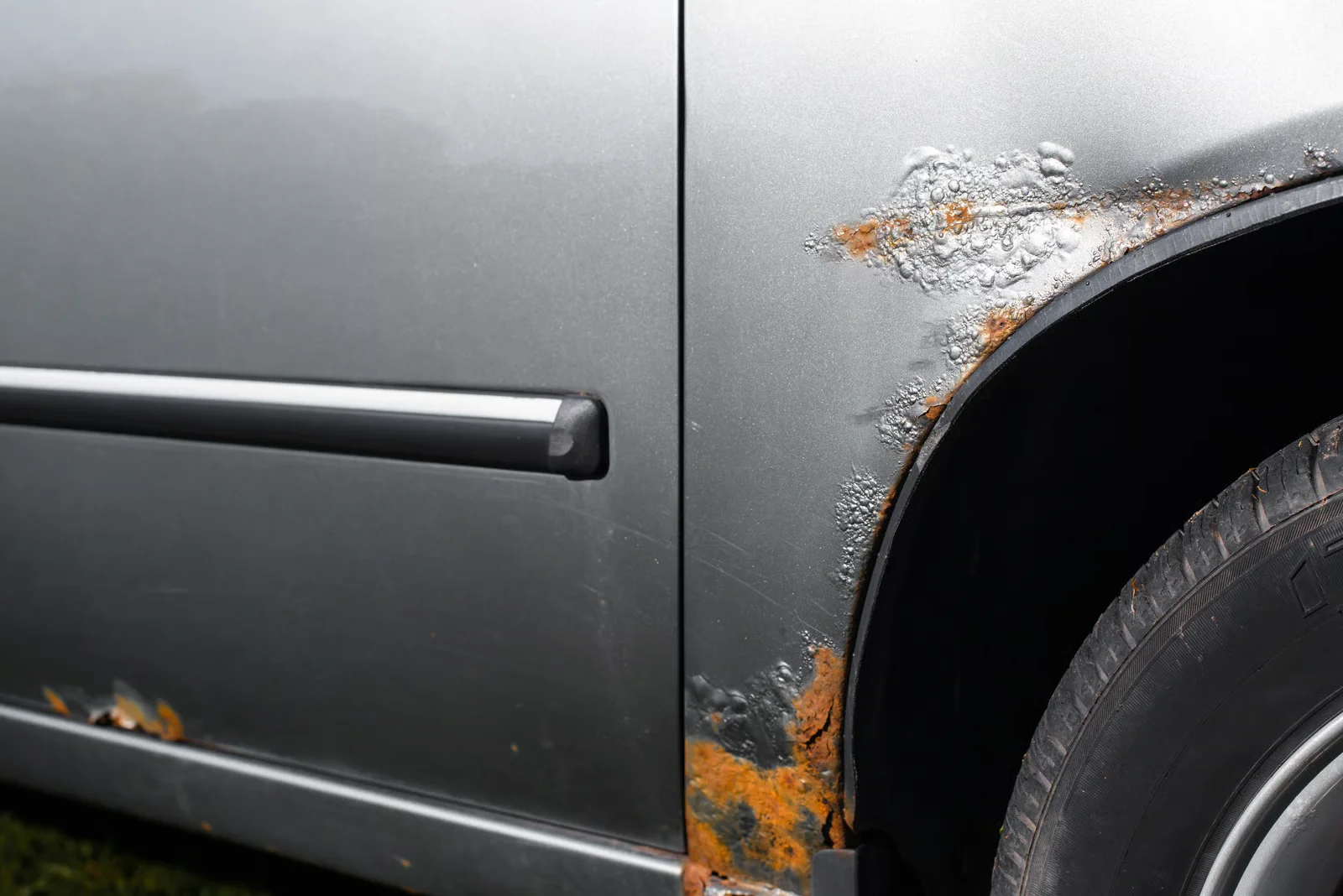 rust damage on the side of vehicle