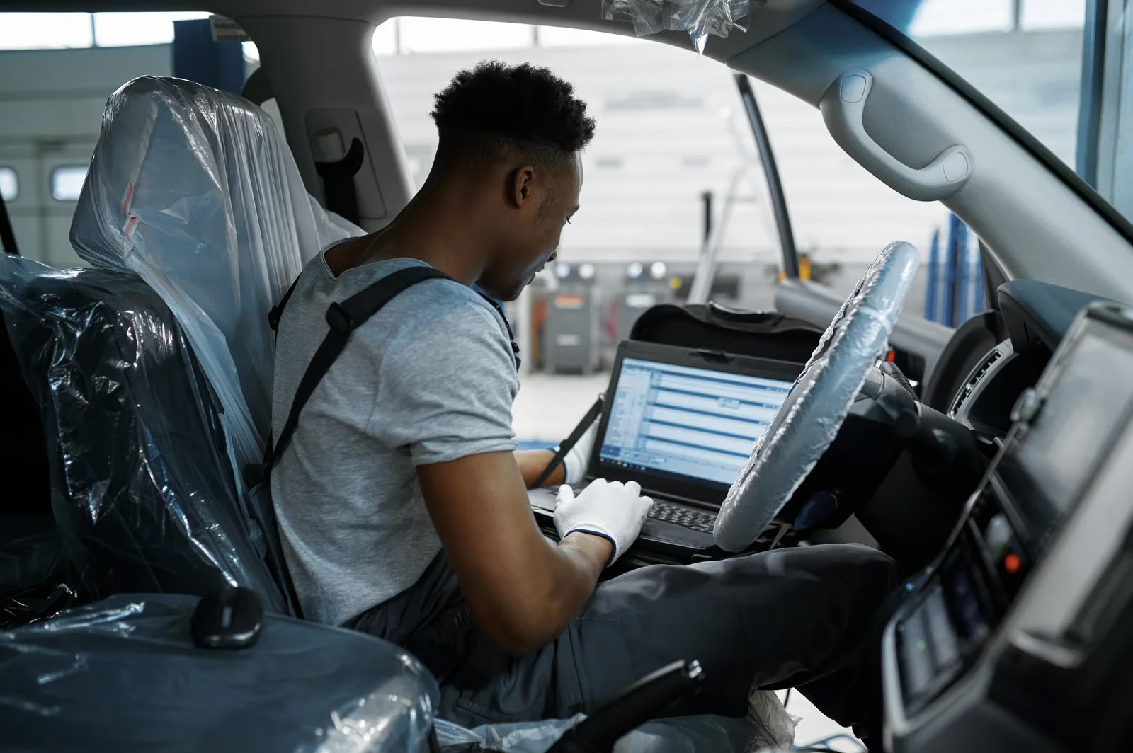 mechanic diagnosing car in auto repair shop